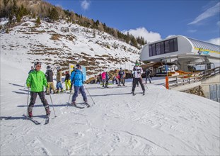 Skiers start at the top station of the Tappenalm cable car on the piste