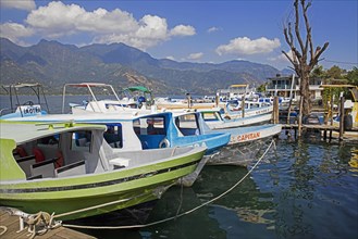 Tourist boats in the little harbour of Santiago Atitlan along the shore of Lago de Atitlan