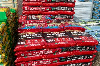 Bags of New Horizon all plant compost on sale in garden centre