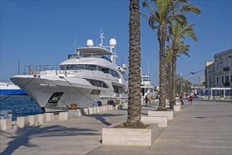 Promenade and motor yachts docked in the seaport