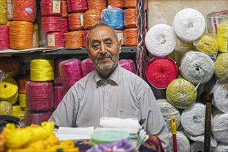 Vendor selling colourful sisal ropes at market in the city Tabriz