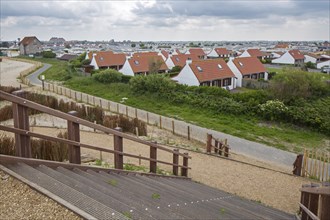 The wooden footbridge Het Wrakhout and holiday resort along the North Sea coast at Westende