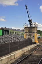 Crane and heap of coal as fuel for steam train at the depot of the Chemin de Fer a Vapeur des Trois Vallees at Mariembourg