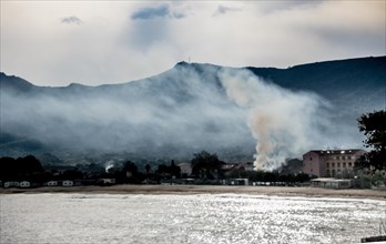 Environment: clouds of smoke from burnt rubbish envelop this site in the west of the Mediterranean island of Corsica