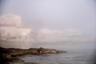 Coastal village in the morning mist