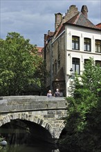 Tourists on the medieval bridge Vlamingbrug in Bruges