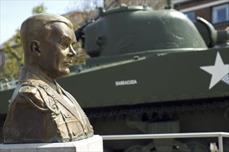 American World War Two Sherman M4A3 Tank of the 11th Armoured Thunderbold Division and bust of General Mac Auliffe in Bastogne