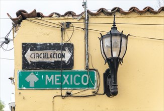 Road signs for Mexico City and Circulacion on side of building