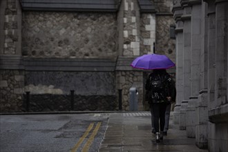Umbrellas in use on a dark and rainy day in the inner city during a period of bad weather. Dublin