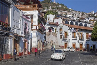 White Volkswagen Beetle taxis on the main square El Zocalo in the colonial city centre of Taxco de Alarcon
