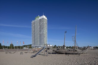 The Maritim Hotel and wooden pirate boat in playground on beach at Travemuende