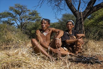 Bushman and San woman making fire in Kalahari