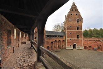 Worn-out red bricks in corridor and inner court of the medieval Beersel Castle