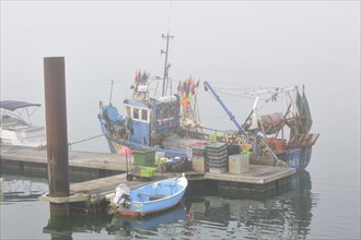 Fishing boat in thick fog in the harbour at Saint-Denis-d'Oleron on the island Ile d'Oleron