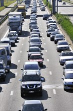 Cars queuing in highway lanes during traffic jam on motorway during summer holidays