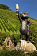 Sculpture Black Cat in front of wine-growing area