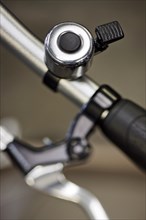Close up of bike bell with external clapper mounted on the handlebars
