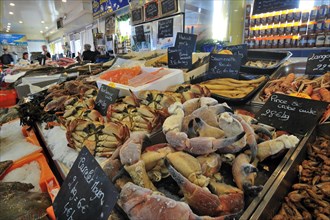 Fresh crabs and seafood on display at fish market in the port of Le Treport