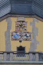 City coat of arms and parapet on the tower of St. John's Minster
