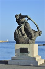 Statue of the hero sailor Herve Rielle in the harbour of Le Croisic