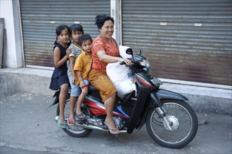 Mother with children on moped