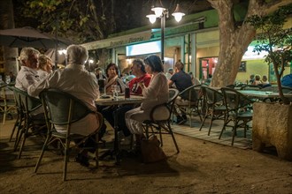 Guests in the evening in a restaurant on the Mediterranean island of Corsica