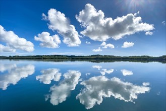 Reflection of clouds Altocumulus in front of blue sky reflected over in Pacific Still ocean without any waves with in mirror smooth sea surface water surface mirror smooth sea