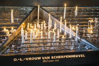 Offered candles burning at the Basilica of Our Lady of Scherpenheuvel