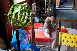 Woman with iron in weaving mill at Inle Lake
