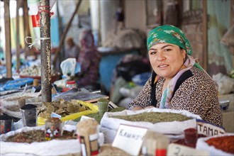 Kyrgyz woman selling spices at the market in Osh