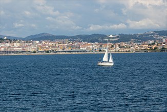 Small boat sailing in estuary of Ria de Vigo