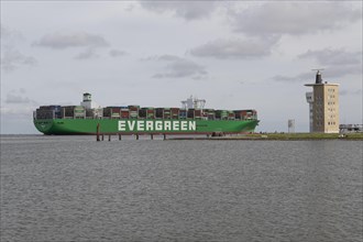 The container ship Ever Goods of the Evergreen shipping company passes the radar tower in Cuxhaven
