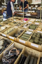 Vendor in WWII stand selling military memorabilia to World War Two collector at WW2 militaria fair