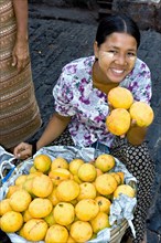 Woman selling mangoes at market