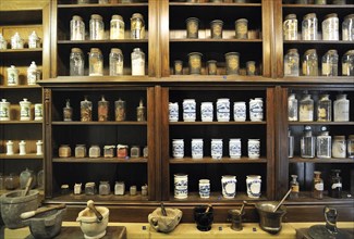 Apothecary cabinet of old pharmacy showing pots and jars with medicines in the Orval Abbey