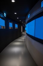 Illuminated Corridor with TV Screens in Switzerland