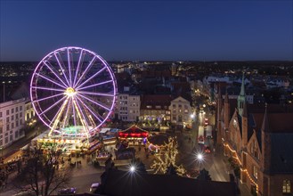Illuminated Ferris wheel at evening Christmas market in winter at Koberg