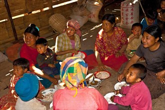 Family in hut eating