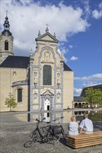 Cyclists resting in front of the 17th century Baroque church of the Averbode Abbey at Scherpenheuvel-Zichem