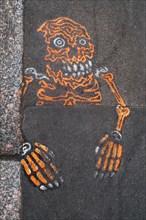 Grafitti of a skeleton on the street