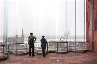 Elderly couple of tourists looking over the river Scheldt from the MAS