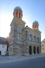 Old synagogue with double towers built 1884 in backlight