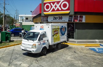 View from bus window Sabritas delivery van vehicle outside OXXO store