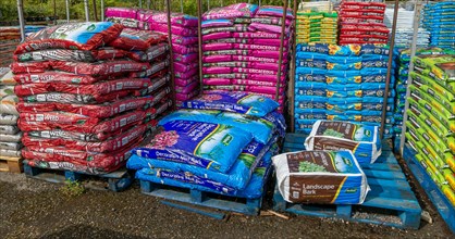 Bags of bark and compost on sale in garden centre