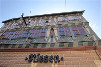 Historic half-timbered house Hotel zum Riesen with inscription and nose sign