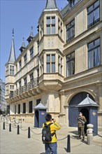 Tourist taking picture of guard in front of the Grand Ducal Palace Palais grand-ducal at Luxembourg