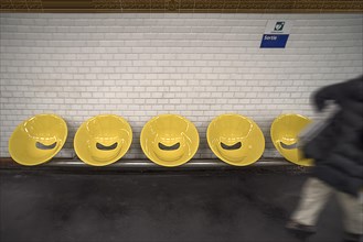 Yellow bucket seats in a Metro station