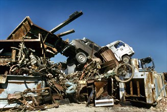 Dumping site with car wrecks and metal household waste for recycling iron and other metals