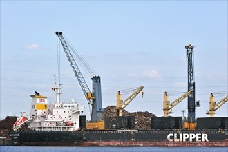 Bulk carrier loading recycled scrap metal in dock at Ghent seaport