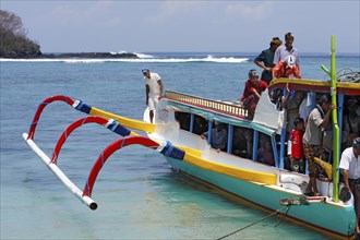 Colourful outrigger boat with passengers